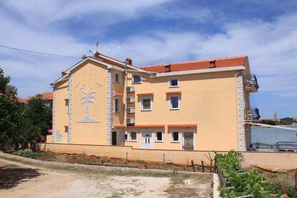a building with a mural on the side of it at Apartments by the sea Kraj, Pasman - 3460 in Pašman