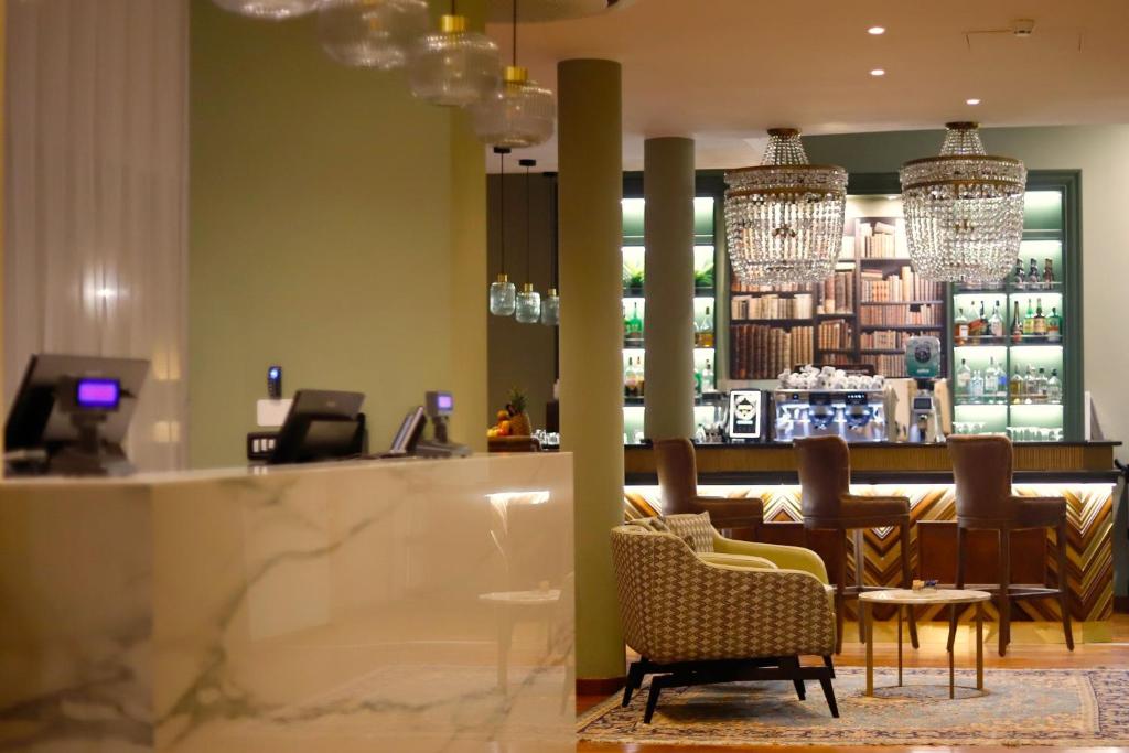 a restaurant with a bar with chairs and a counter at Hotel Indigo Turin, an IHG Hotel in Turin