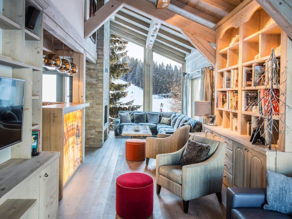 a living room with a couch and a tv at Chalet Les Gets, 8 pièces, 14 personnes - FR-1-627-1 in Les Gets