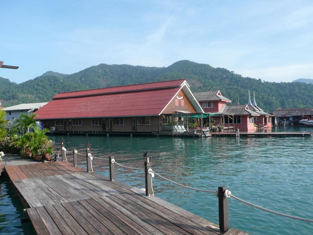 a building on the water next to a dock at Oceanblue Guesthouse in Ko Chang