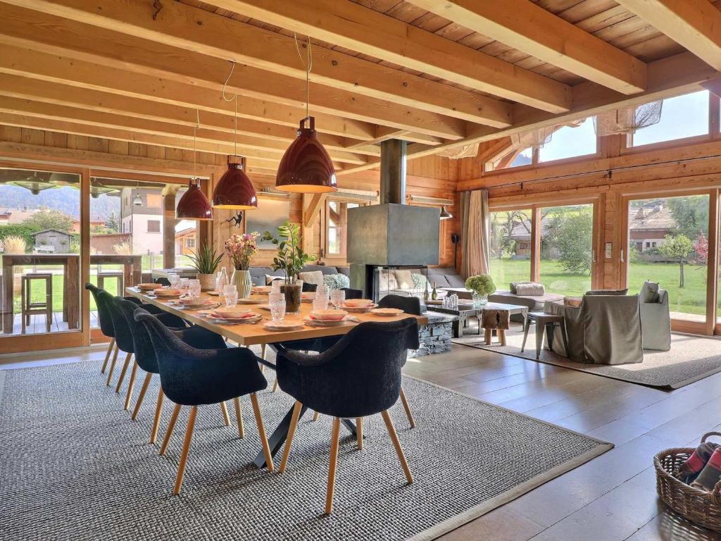 a dining room with a wooden table and chairs at Chalet Morzine, 6 pièces, 13 personnes - FR-1-627-8 in Morzine
