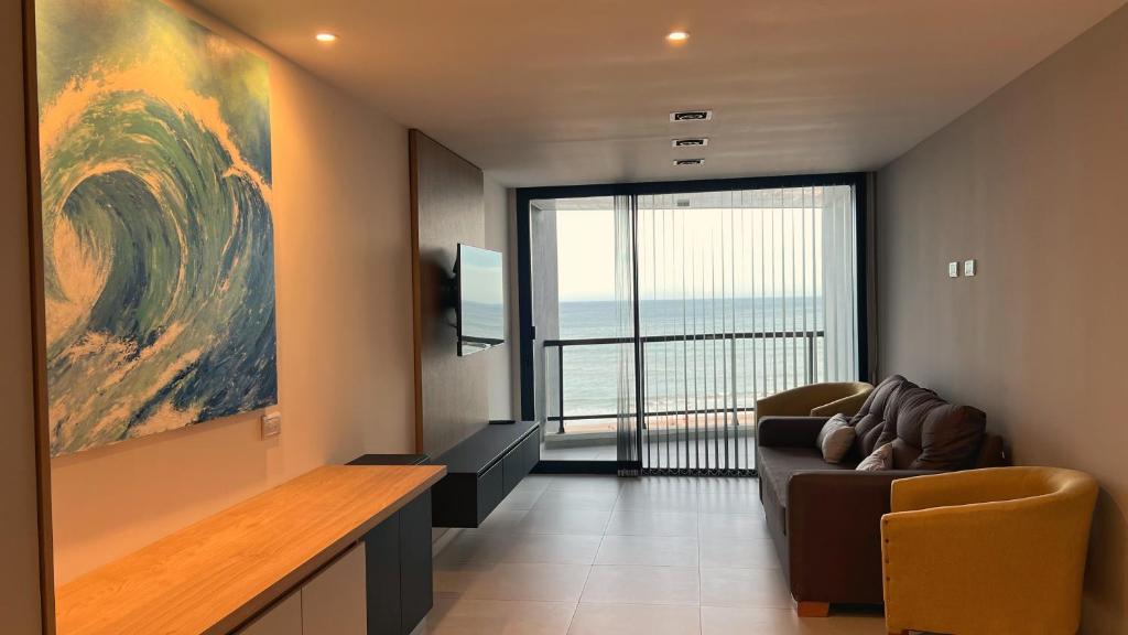 a living room with a couch and a large window at Remanso de Mar in Mar del Plata