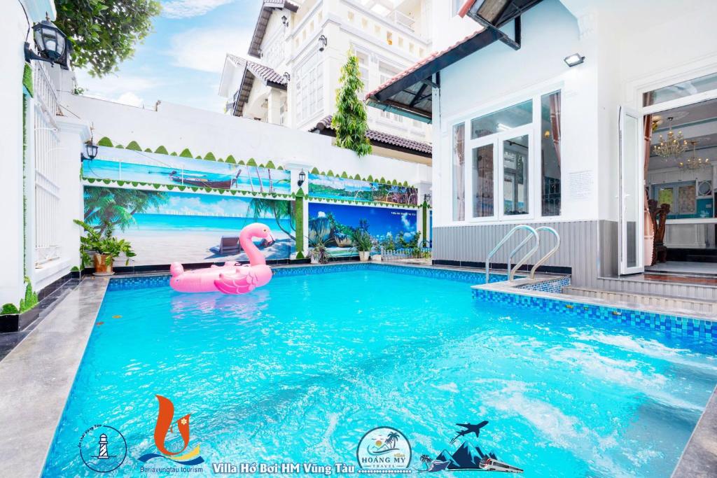 a pool in a house with a pink flamingo in the water at Villages HOÀNG ĐỨC gần biển XANH in Vung Tau