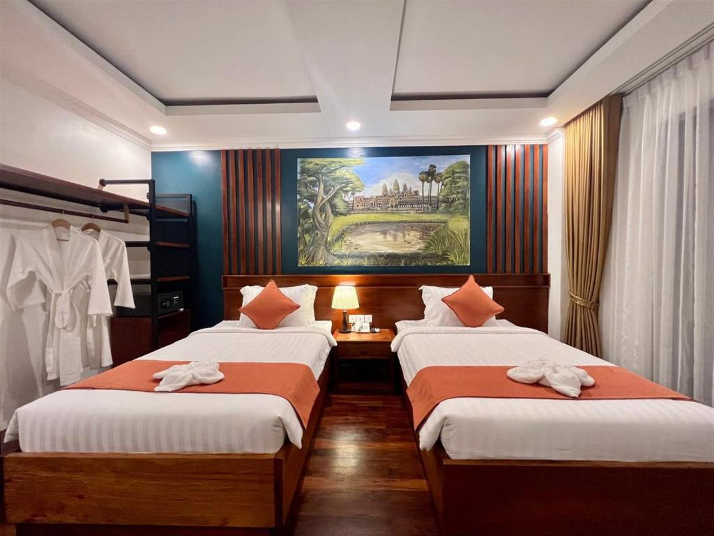 Postel nebo postele na pokoji v ubytování Le Vert Angkor Hotel