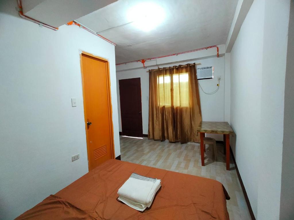 Habitación pequeña con cama y ventana en AUNORA ROOMS with AC, 