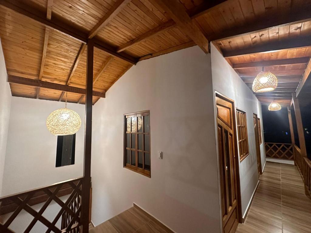 a hallway of a house with wooden ceilings at Cabaña El Cangrejo Azul - Blue Crab House in San Onofre