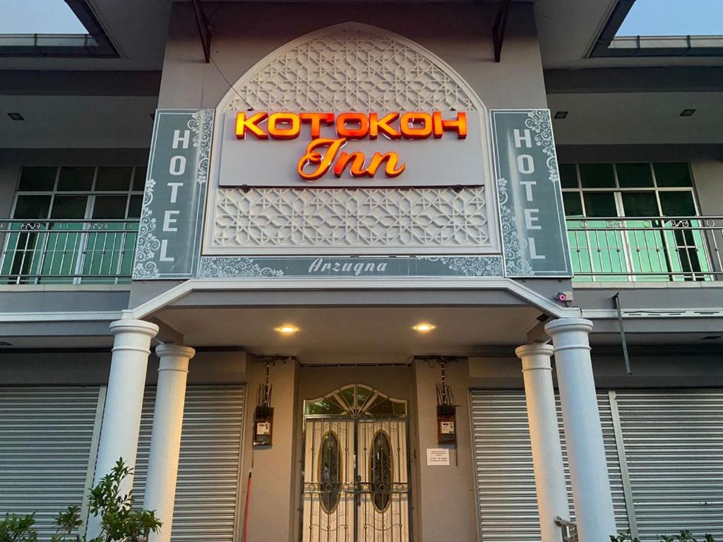a building with a sign that reads kotsuch gin at KOTOKOH INN in Machang