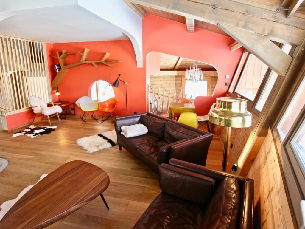 a living room with a leather couch and orange walls at Chalet Avoriaz, 6 pièces, 10 personnes - FR-1-314-100 in Avoriaz