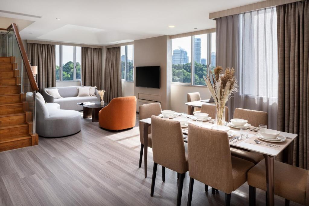 a dining room and living room with a table and chairs at Park Avenue Clemenceau in Singapore