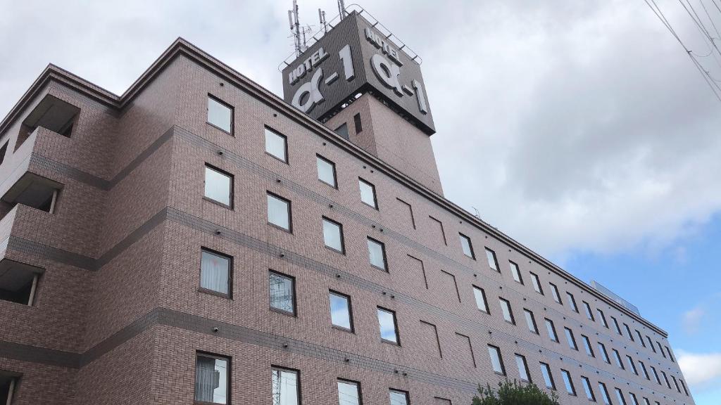 a building with a clock tower on top of it at Hotel Alpha-One Otsu in Otsu