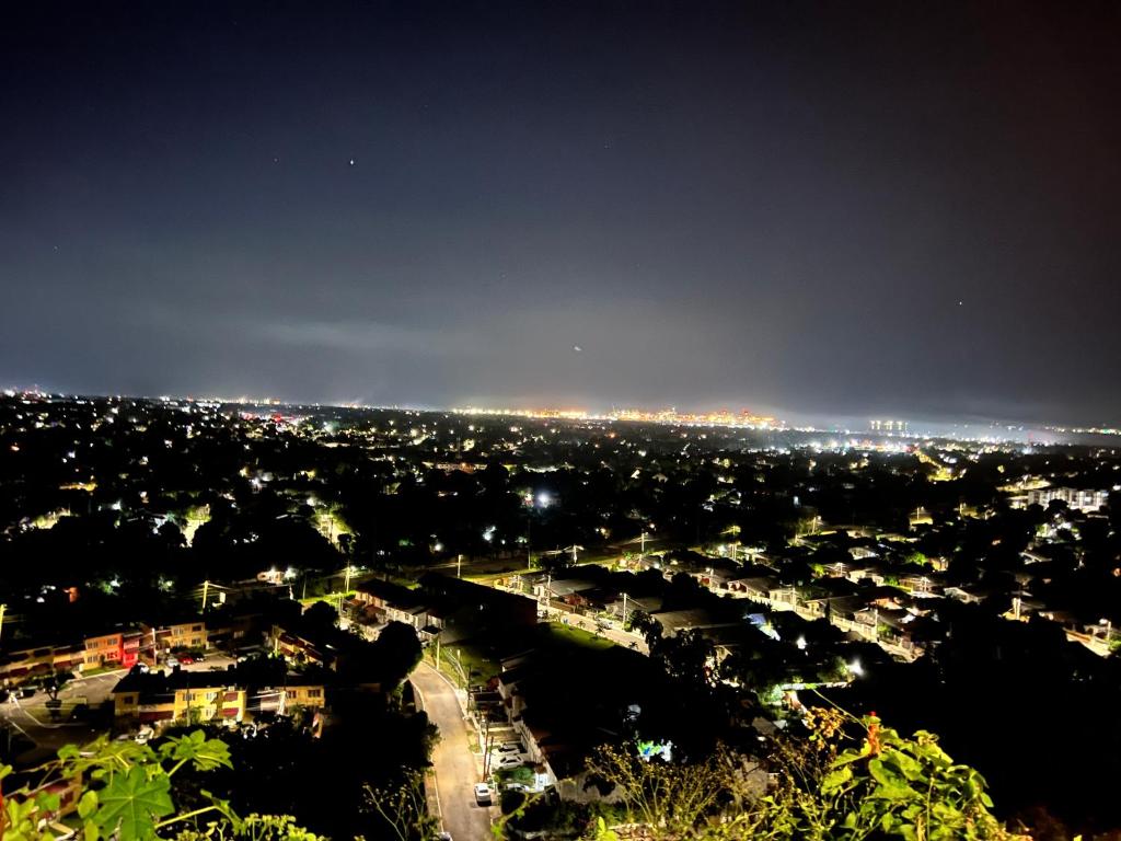 a view of a city at night with lights at Netfa's Hidden Gem in Kingston