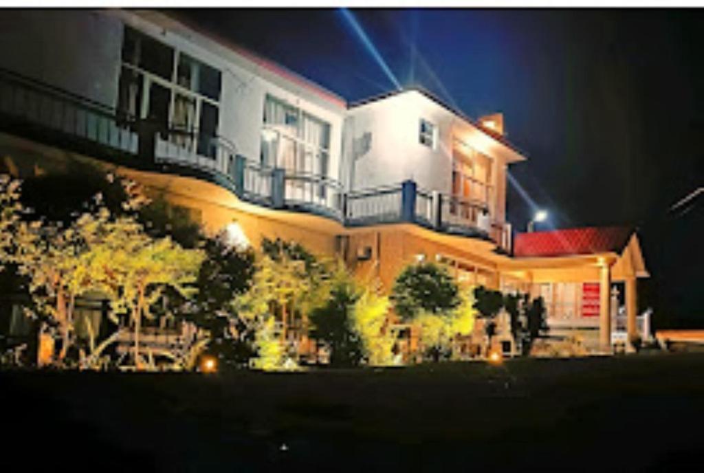 a large building at night with lights at River view resort Uttarkashi in Uttarkāshi