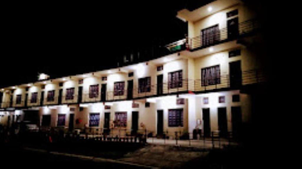 a lit up building at night with lights at Hotel Vikram Palace Sapeta in Barkot