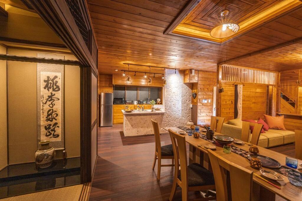 a kitchen and living room with a table and chairs at 『てぃぐまの宿』地平線まで見渡せる圧巻の屋外テラスビュー！300余年の歴史ある壺屋焼がご堪能出来る宿 in Miyako Island