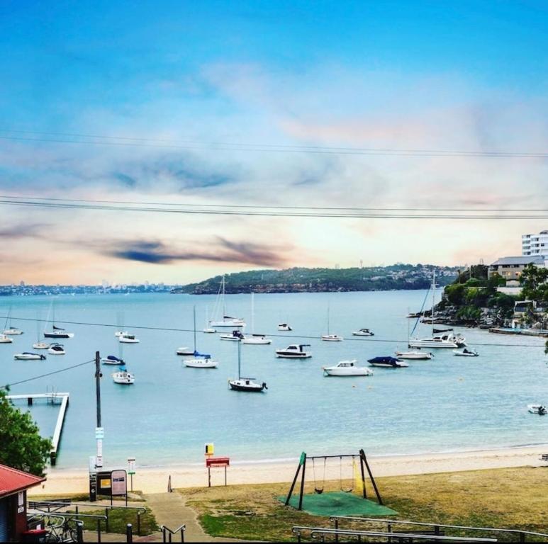 a group of boats in the water with a playground at Little Manly 3 bedroom Oasis in Sydney