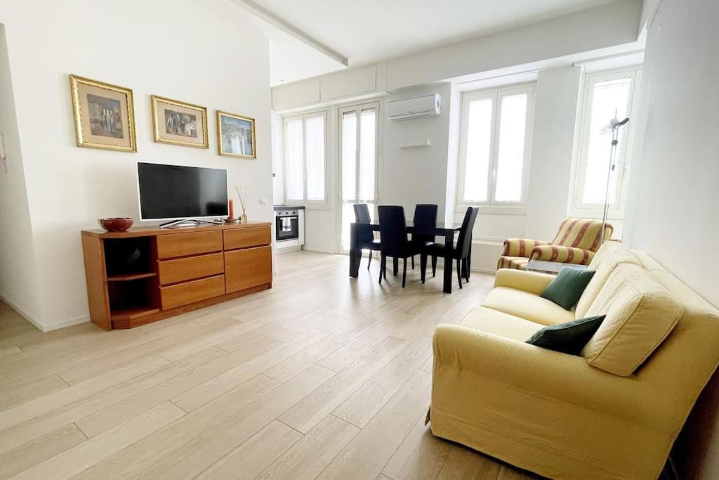 a living room with a couch and a tv at Charlotte House City Center in Milan