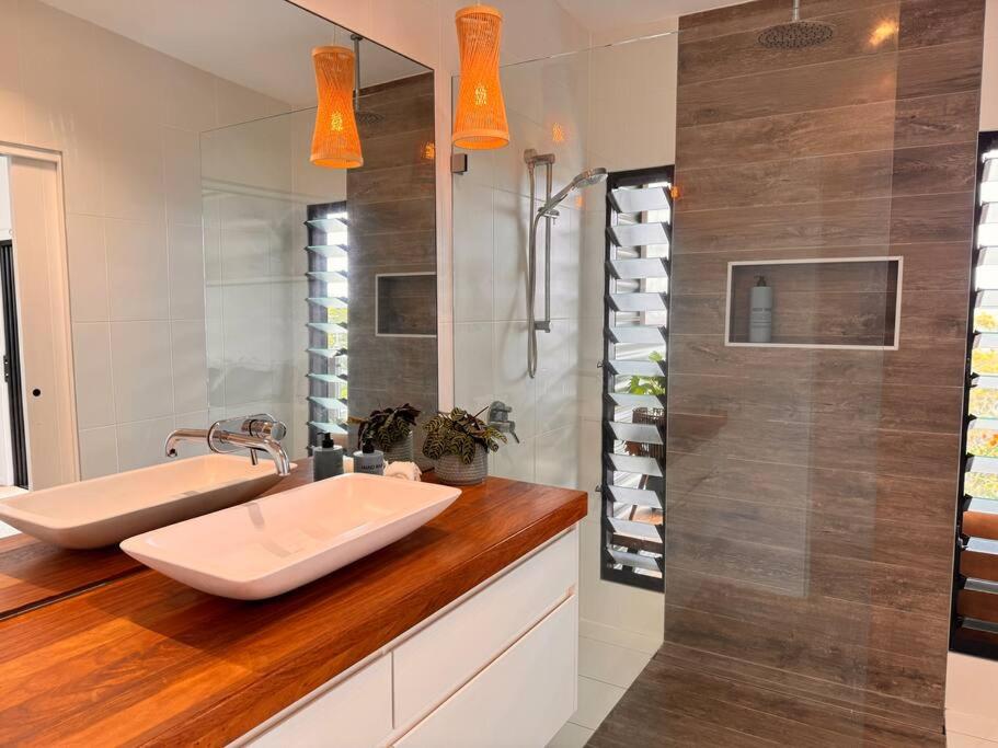 a bathroom with two sinks and a shower at Shed. Holiday Apartment in Nelson Bay