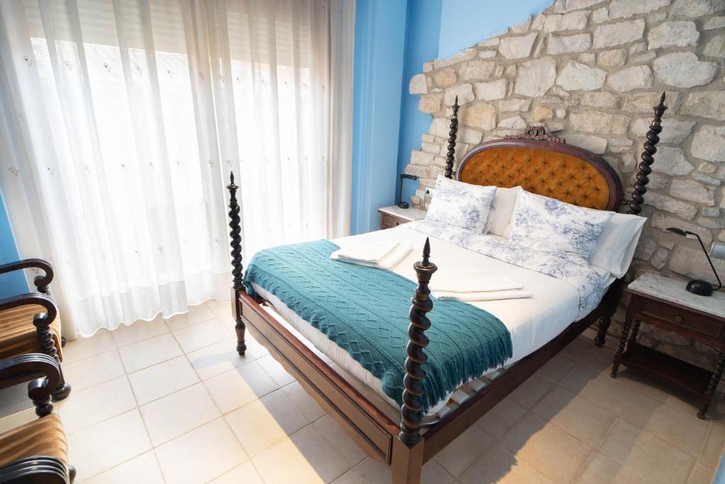 a bedroom with a bed with a stone wall at Enoturismo Celler Piñol in Batea