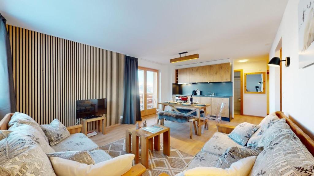 a living room with a couch and a kitchen at Pracondu 1 301 - OUTDOOR & FUN apartment 6 pers in Nendaz