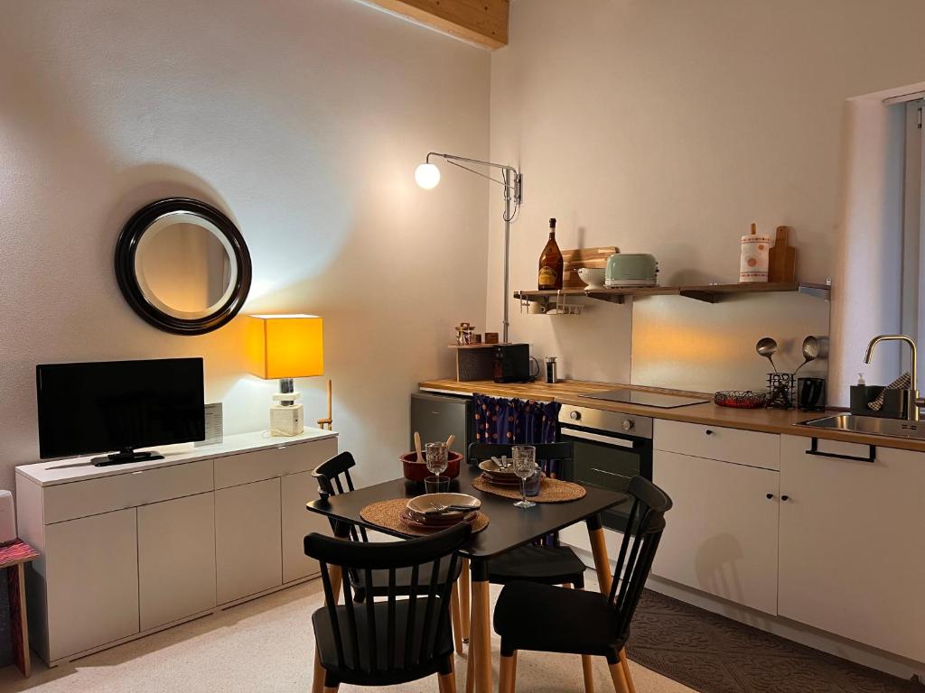 a kitchen with a table and chairs in a room at Garibaldina75 in Cesena