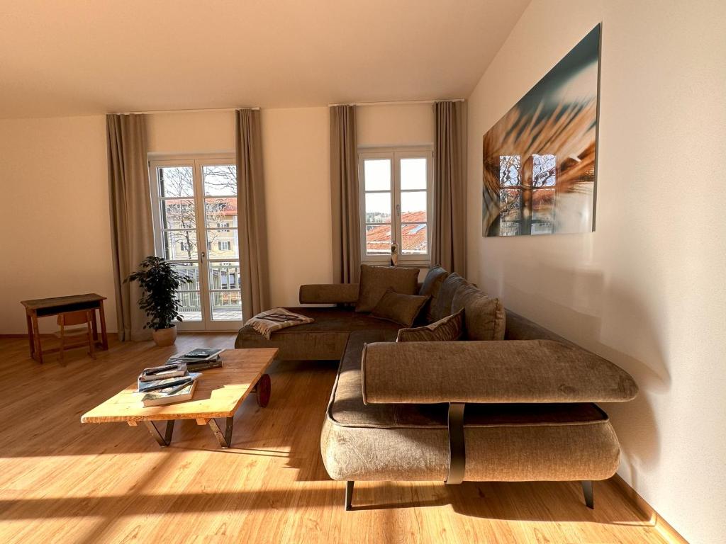 a living room with a couch and a table at muchhome LUXURY APARTMENTS - Stilvolle Apartments am Tegernsee in Gmund am Tegernsee