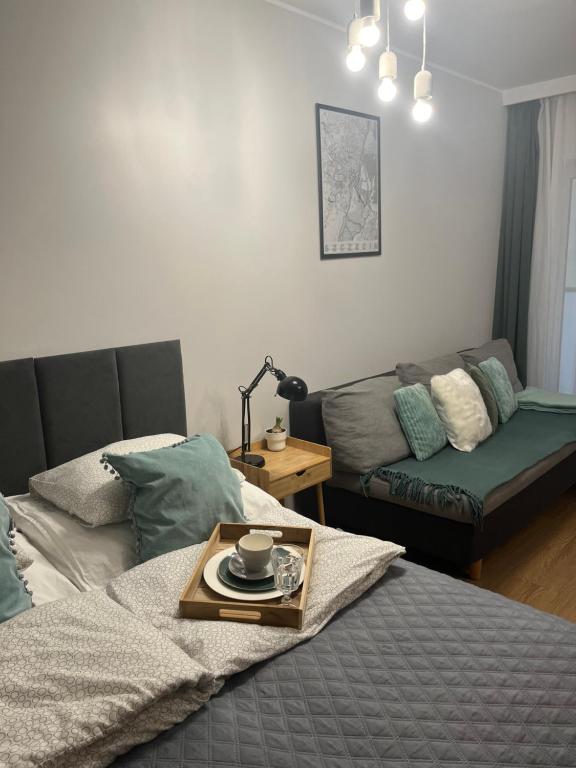 a living room with a bed and a couch at Yellow Stone Apartment in Szczecin