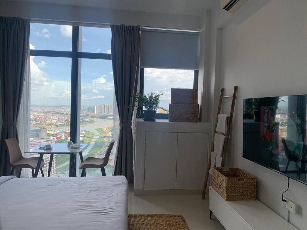 a bedroom with a bed and a view of a city at ZX Service Apartment in Phnom Penh
