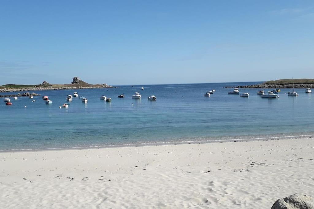 a group of boats in the water on a beach at résidence korejou plages in Plouguerneau