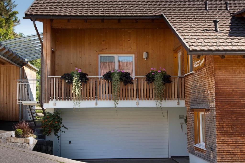 una casa con un balcón con flores. en Appartment Hammerer en Schwarzenberg im Bregenzerwald