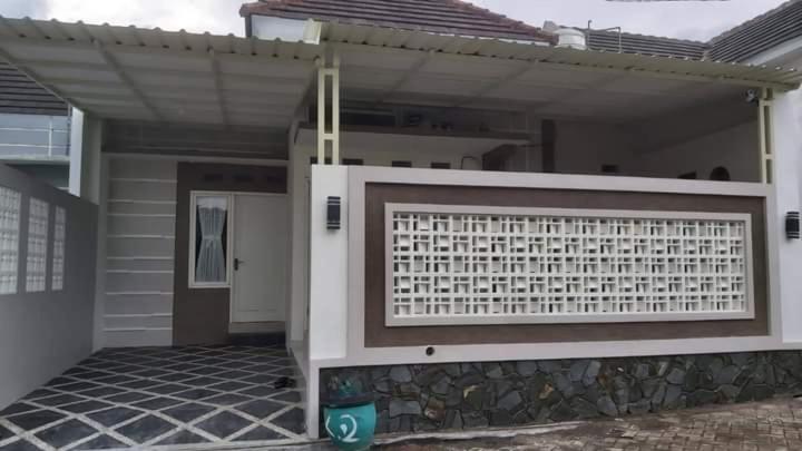 a house with a gate in front of it at Kavilla2 Regency in Karangploso