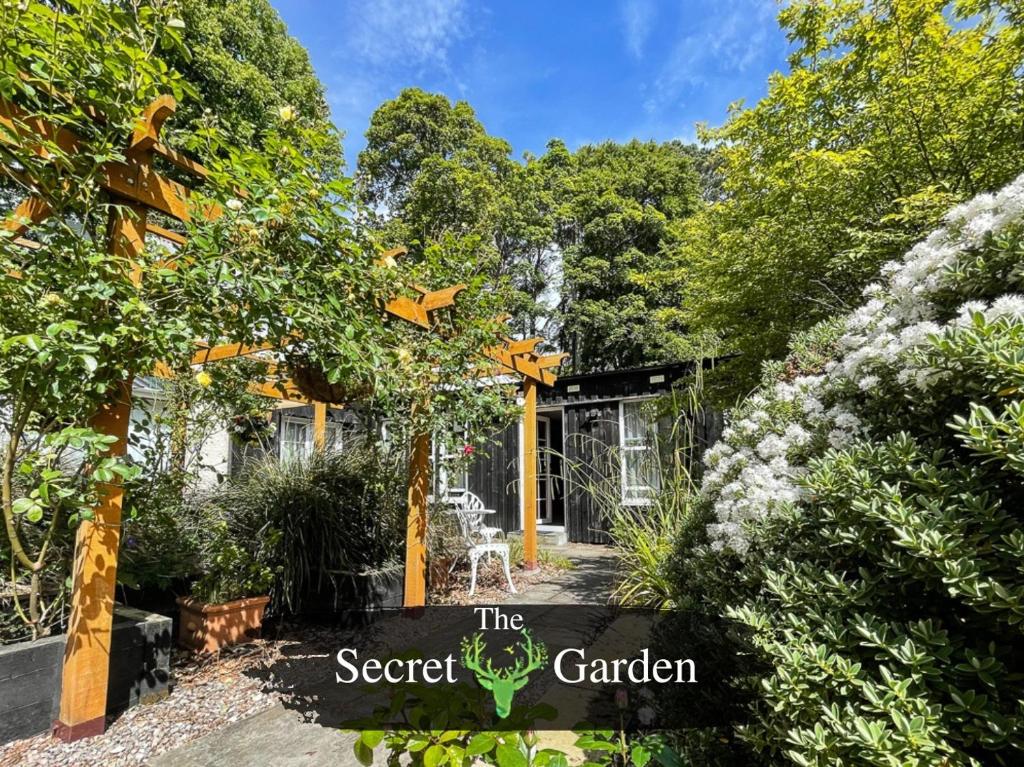 a garden with a sign that reads the secret garden at The Secret Garden at Old Drynie House in Inverness