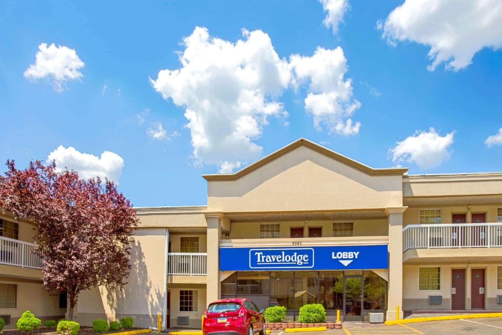 a hotel with a car parked in front of it at Travelodge by Wyndham Silver Spring in Silver Spring