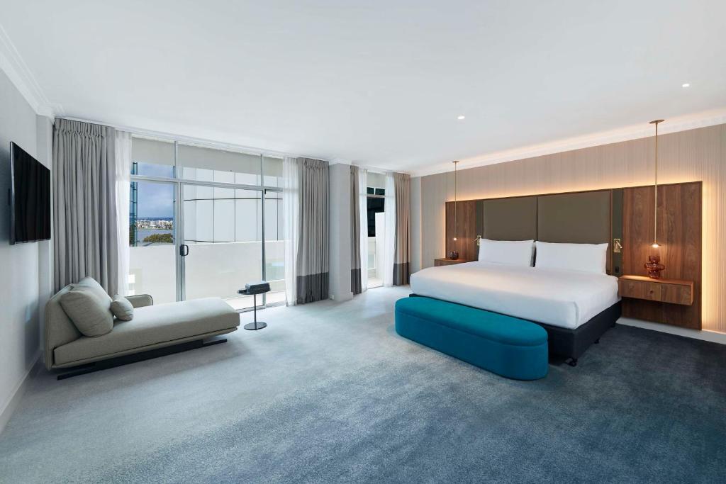 a hotel room with a bed and a couch at Parmelia Hilton Perth in Perth