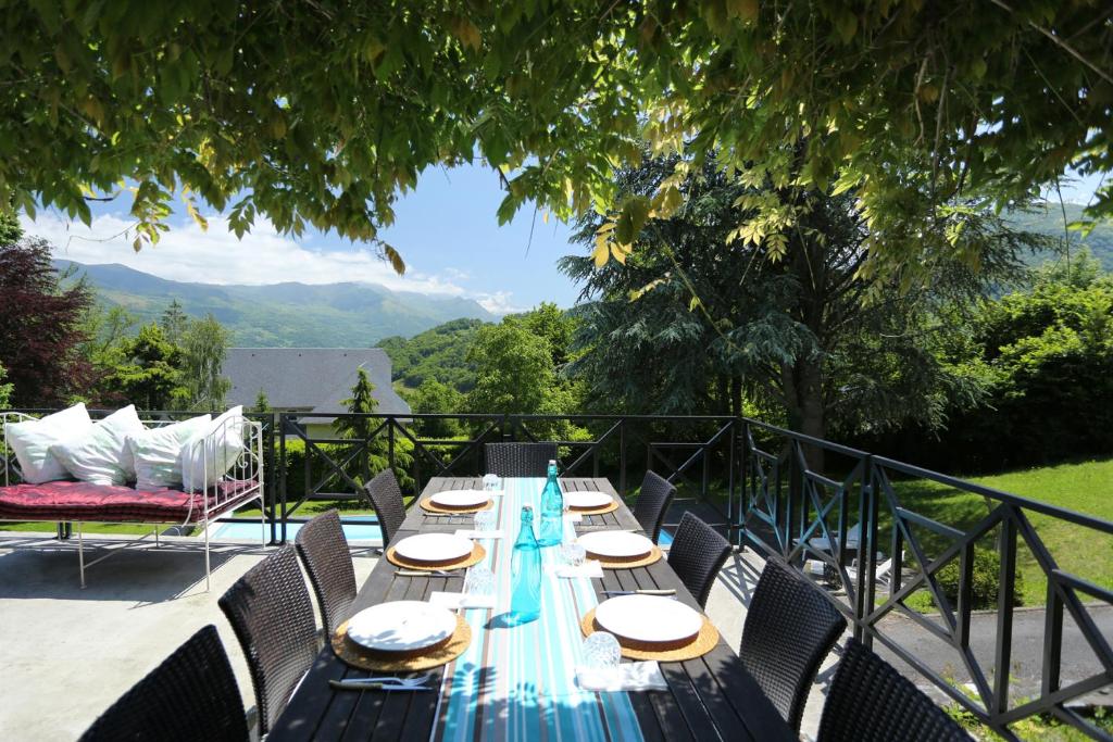 a long blue table with chairs and a view at Le Belvedere in Salles