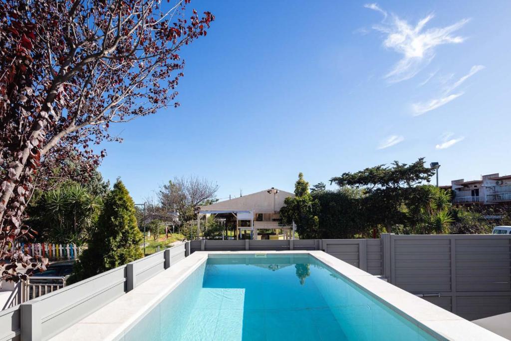 a swimming pool in the backyard of a house at Akonizia Luxury House - With Private Heated Pool and Jacuzzi in Dhrámia