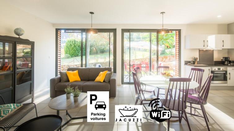 a living room with a couch and a table at Plein Sud avec Jacuzzi Privatif et parking privé in Sarlat-la-Canéda