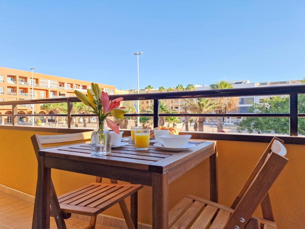 a table and chairs on a balcony with a view at MEDANO4YOU Brisas Del Atlantico in El Médano