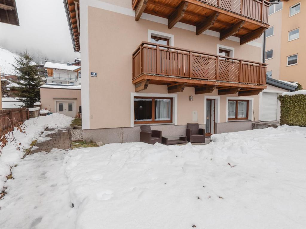 a house with a balcony in the snow at Apartment Sattlerweg by Interhome in Heissingfelding