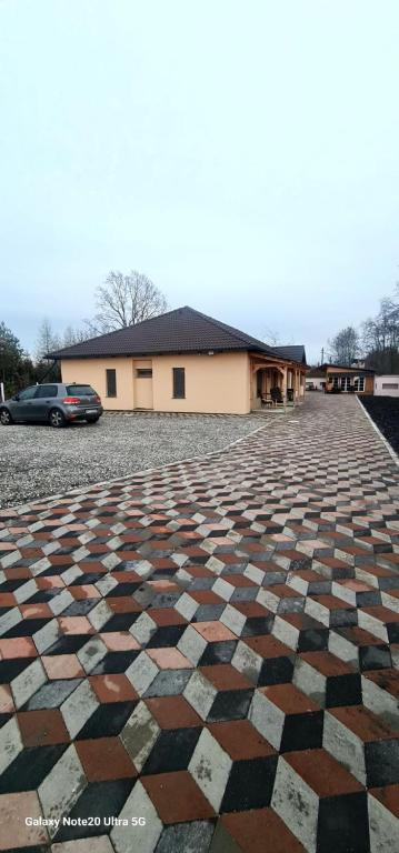a checkered parking lot in front of a building at LukAmi Green Home in Făgăraş