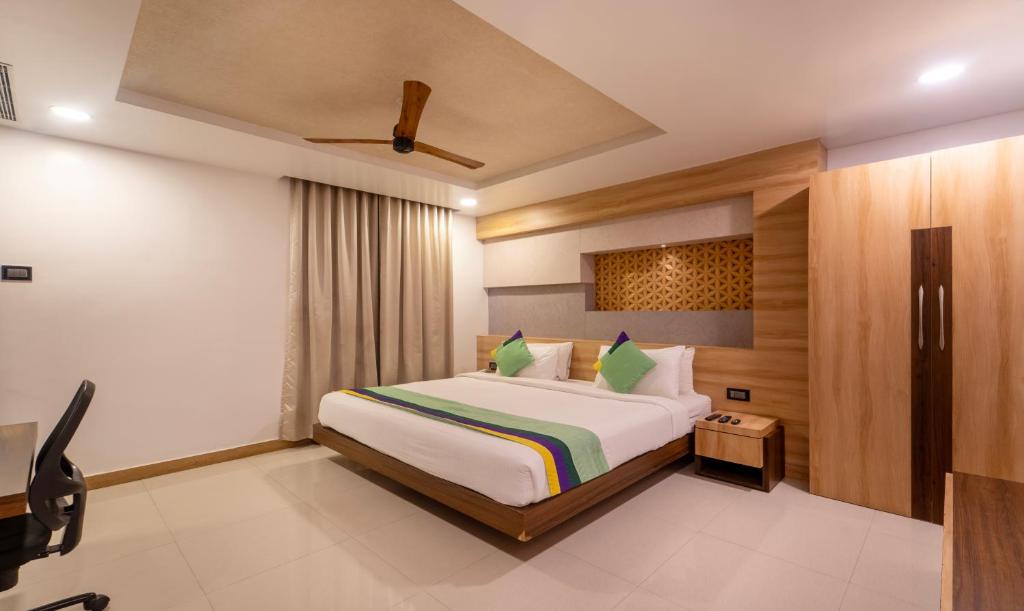 a bedroom with a large bed in a room at Treebo Trend Golden Swan Airport Free Pick & Drop in Chennai