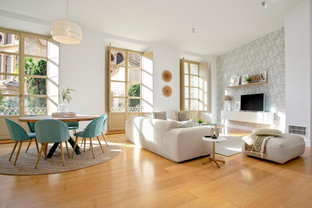 sala de estar con sofá blanco y mesa en Genteel Home San Agustín, en Málaga