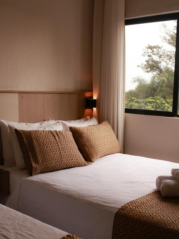 Postel nebo postele na pokoji v ubytování Iguassu Express Hotel