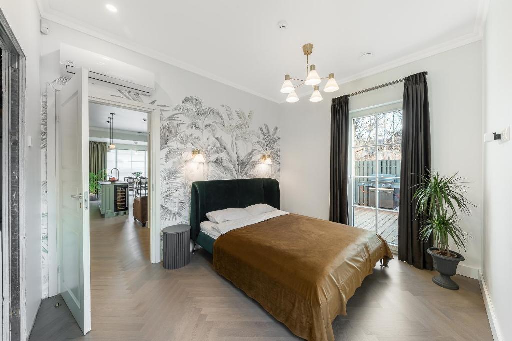 a bedroom with a bed and a large window at Vilnius legends house APARTMENT I Best for families I Free parking in Vilnius