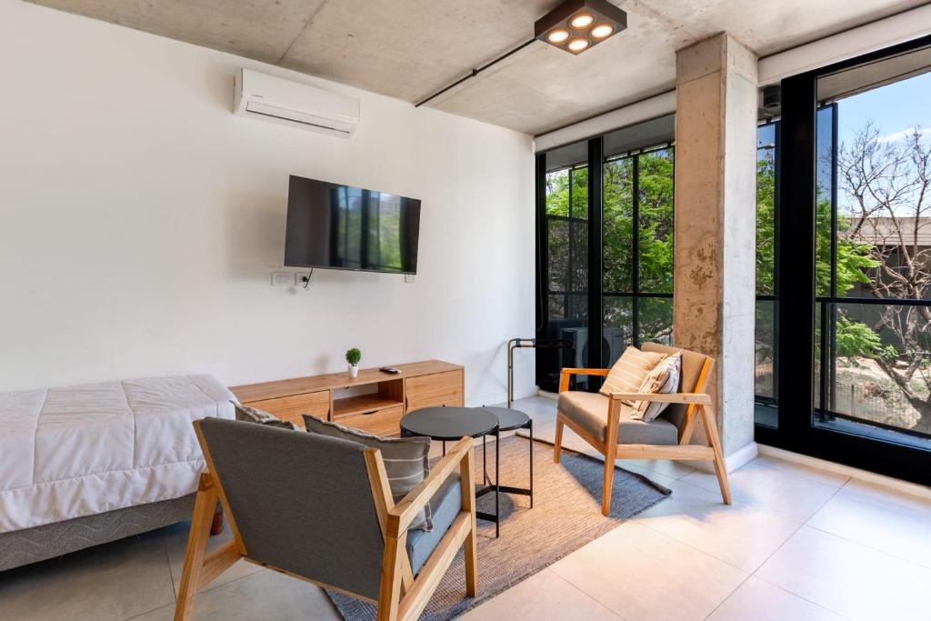 a bedroom with a bed and a table and chairs at NUEVO Loft triple a 5 minutos de Puerto Madero 1A in Buenos Aires