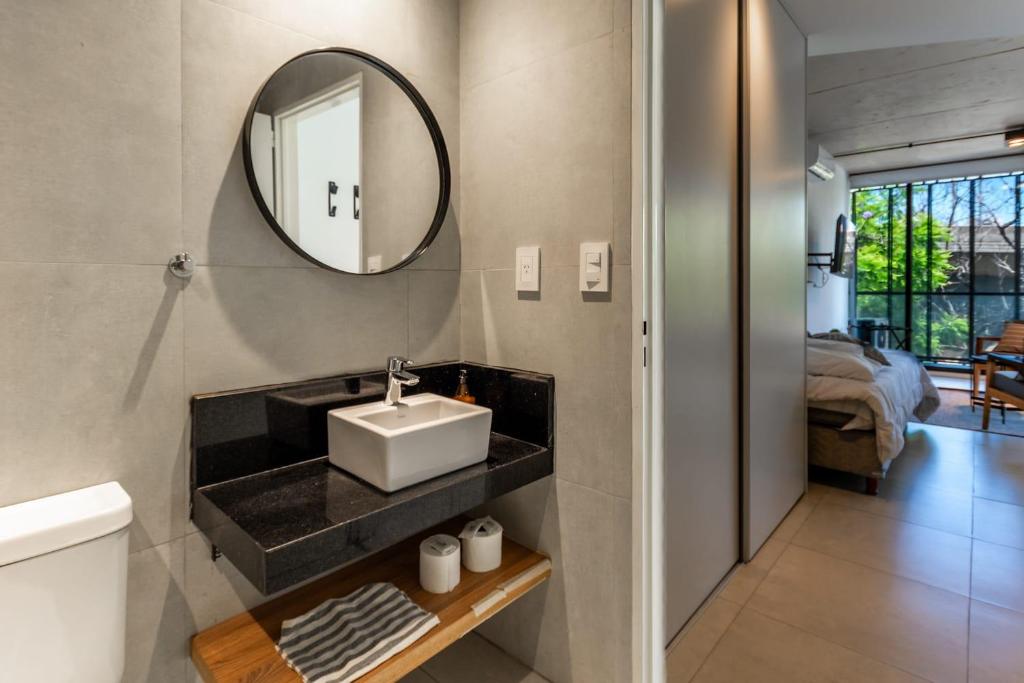 a bathroom with a sink and a mirror at NUEVO Loft triple a 5 minutos de Puerto Madero 1A in Buenos Aires