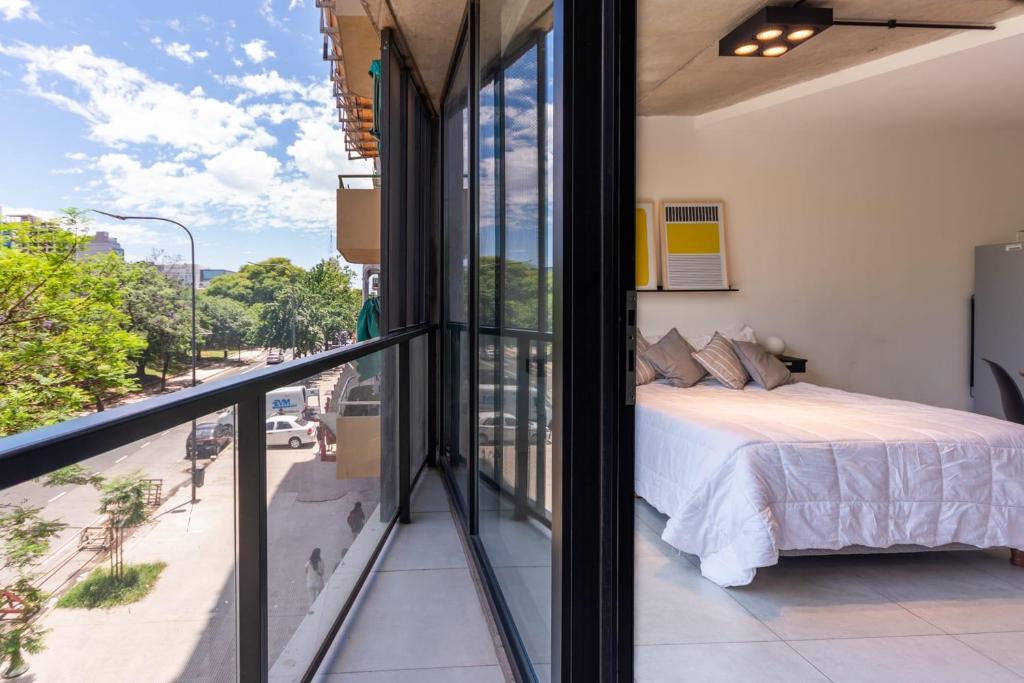 a bedroom with a bed and a view of a street at NUEVO Loft triple a 5 minutos de Puerto Madero 1A in Buenos Aires