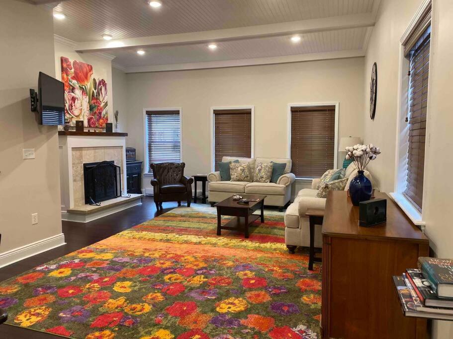 a living room with a couch and a fireplace at The Cast Iron Lady in Wyalusing