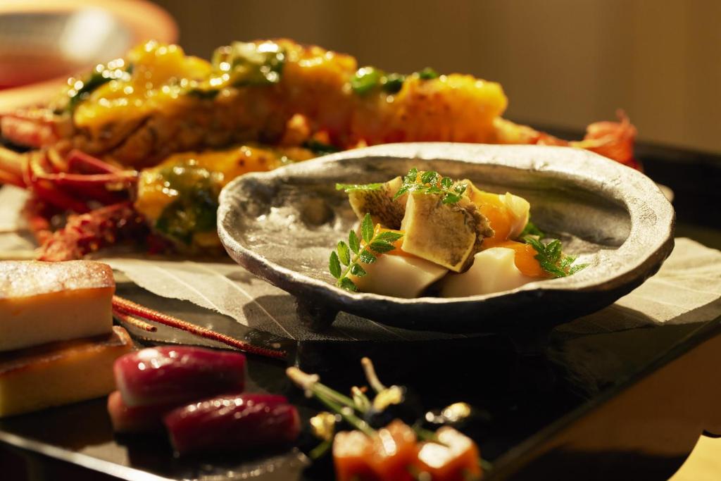 a table topped with two bowls of food on a table at Waqoo Naritasanmonzen in Narita