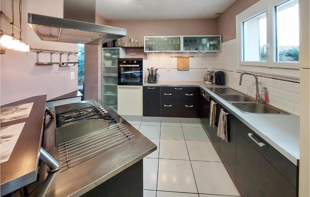 a kitchen with a sink and a counter top at Beautiful Home In Angresse With Wi-fi in Angresse