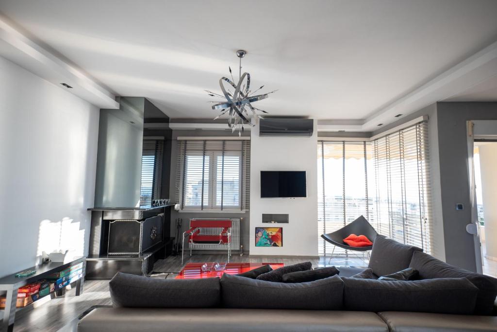 a living room with a couch and a fireplace at F & B Collection - Seaview 2 Bedroom Flat in Thessaloniki